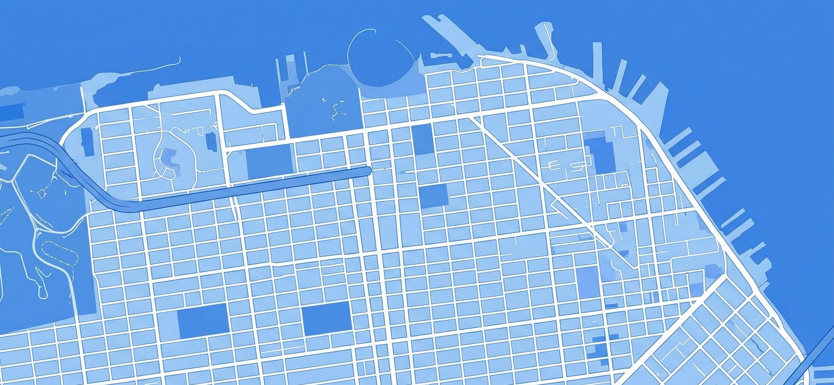 Blueprint desk with laptop analytics overlay